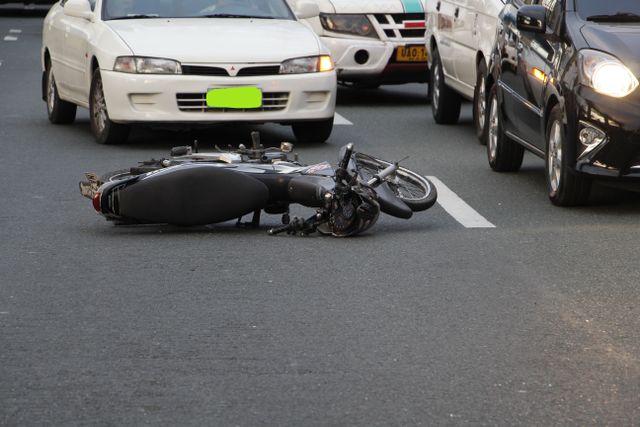 Motorcycle accident lawyer in Bakersfield reviewing a downed motorcycle after a crash